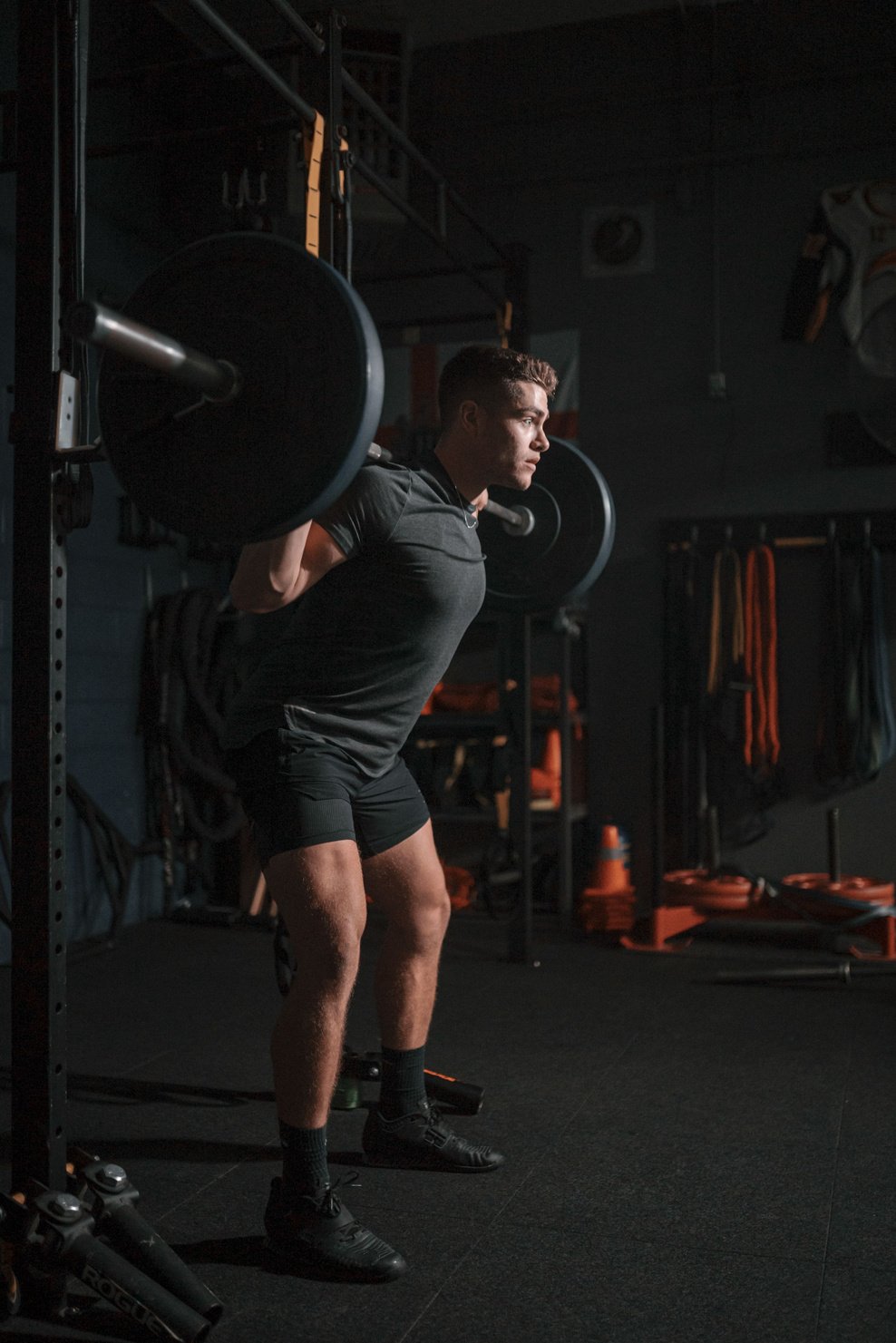 Vertical shot of a Caucasian man exercising the gym